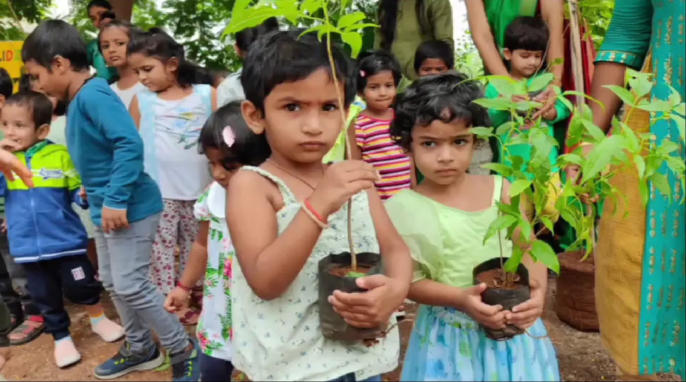 Children holding saplings on plantation day