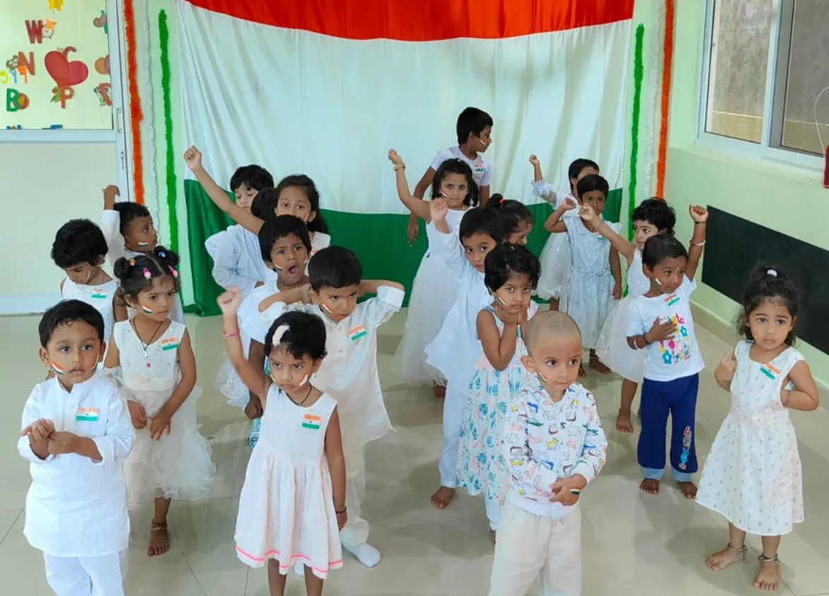 Children in white waving flags on Republic Day