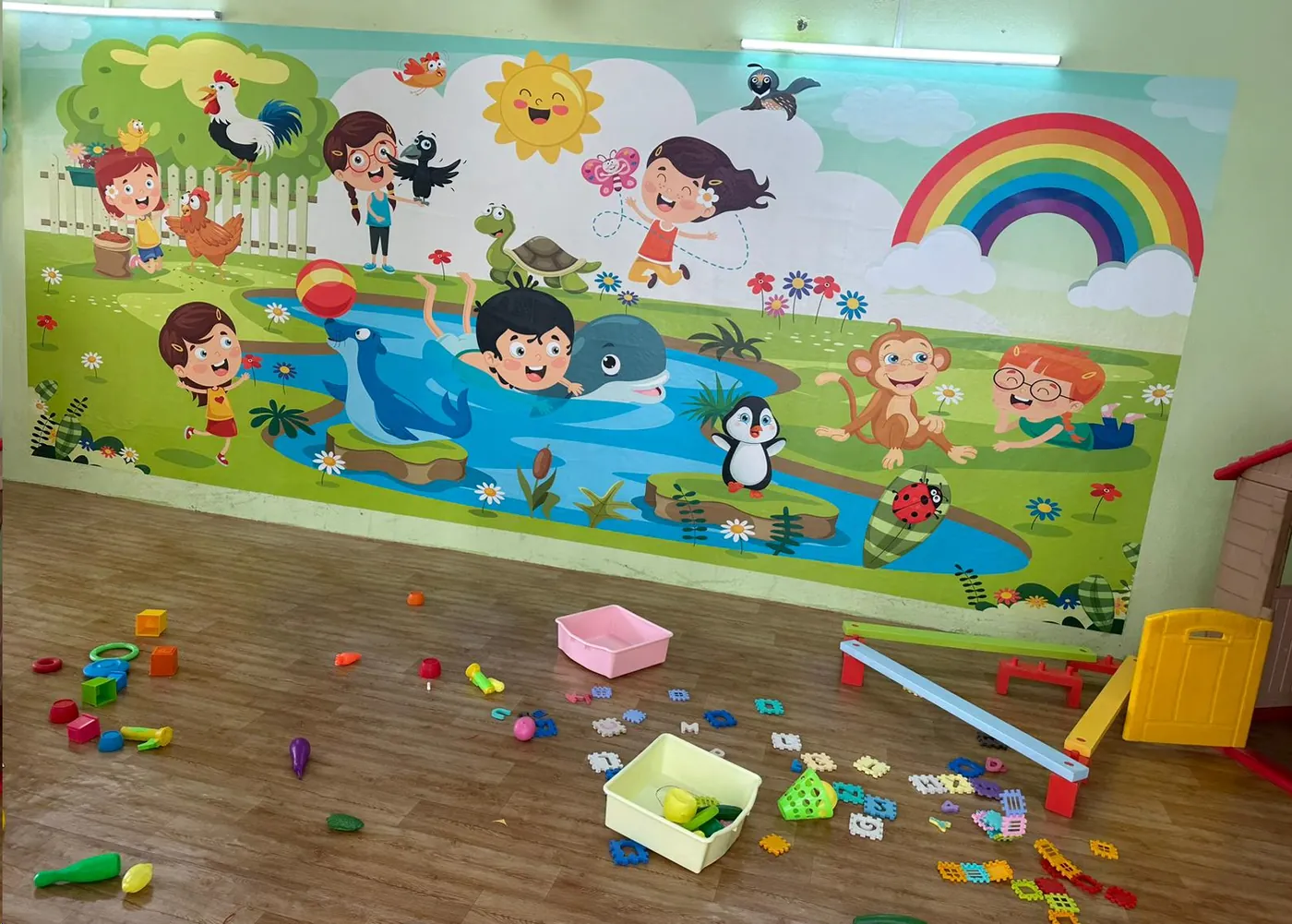 The Kidzlore play area, with a painted mural wall and soft flooring